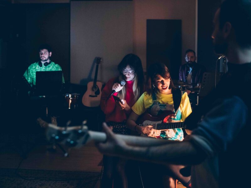 Music band performing in a recording studio - Musician rehearsing studio - concert, recording, having fun concept